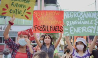 Young people hold up banners in the Philippines about climate change.