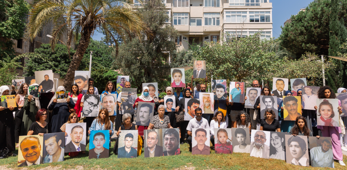 Family members of people who have been forcibly disappeared in the Middle East gather outside venue marking day of the disappeared in Beirut holding photos of their missing loved ones.