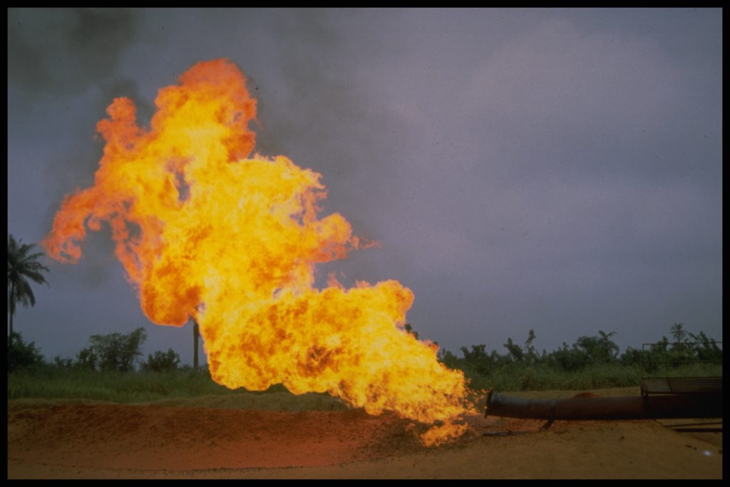 an enormous flume of fire pours out of an exhaust pipe