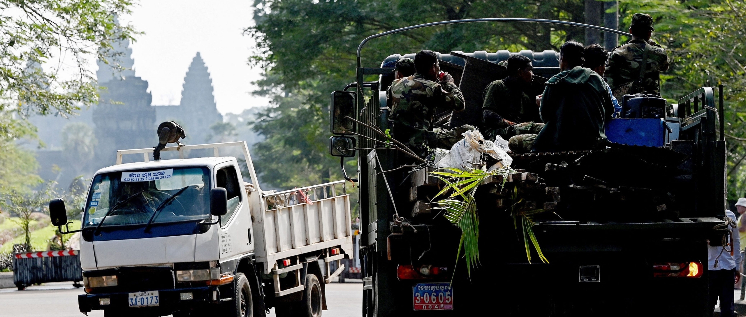 This photo taken on January 18, 2023 shows a military truck transporting the belongings of a resident past the Angkor Wat temple in Siem Reap province. The military was involved in moving residents who volunteered to move from Angkor to the resettlement site of Run Ta Ek. But many residents told Amnesty the moves were not voluntary.