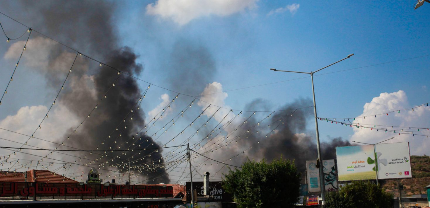 Smoke seen rising from shops and homes belonging to Palestinians following an attack by Jewish settlers on the Palestinian town of Deir Sharaf, following a shooting attack that led to the death of an Israeli near the area, in the town of Deir Sharaf, west of Nablus, in the northern West Bank.