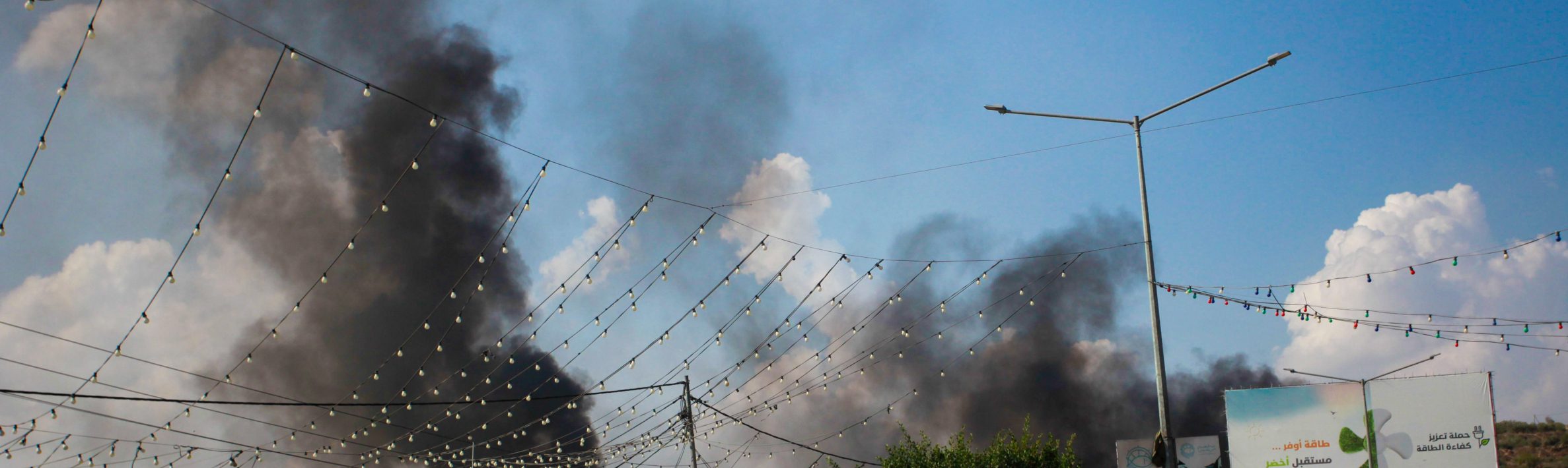 Smoke seen rising from shops and homes belonging to Palestinians following an attack by Jewish settlers on the Palestinian town of Deir Sharaf, following a shooting attack that led to the death of an Israeli near the area, in the town of Deir Sharaf, west of Nablus, in the northern West Bank.