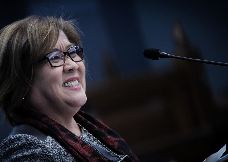 Portrait of Senator Leila De Lima stood in front of a microphone