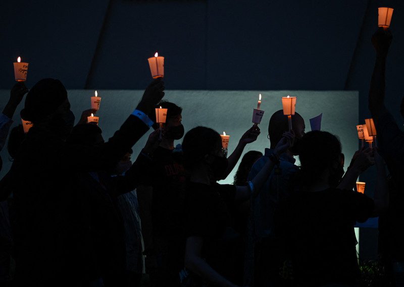 Activists hold up lights in a vigil against the impending execution of Nagaenthran K. Dharmalingam