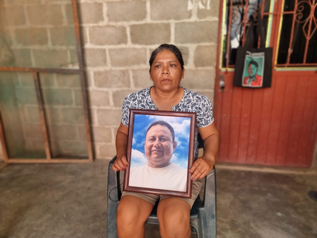 Gustavo Sánchez's widow Marilú Salinas Zárate holds a framed photo of him