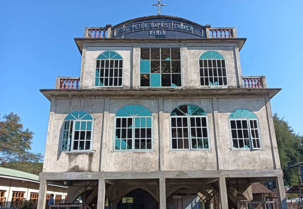 A photograph showing the damaged building of the St Peter Baptist Church in Kanan. The windows are blown out.