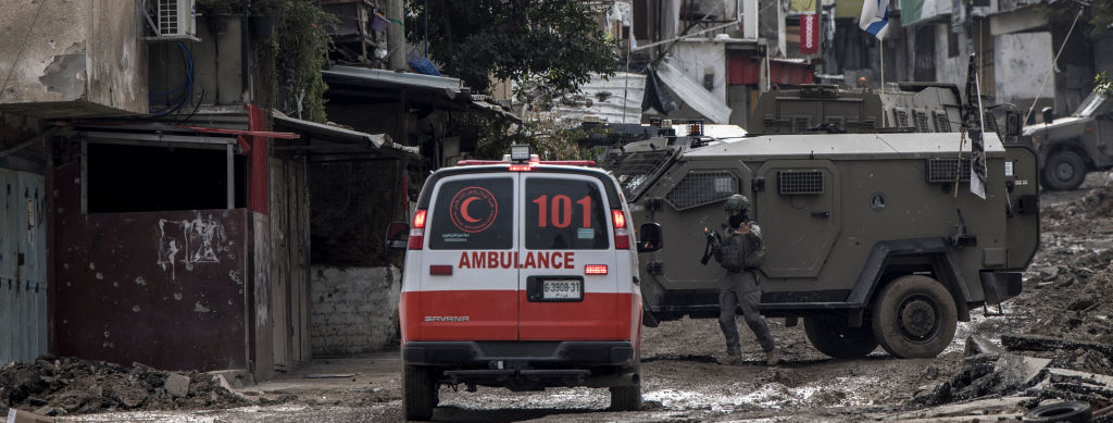 An Israeli soldier gestures towards a Palestinian Red Crescent ambulance at the entrance of the Tulkarem refugee camp in Tulkarem, in the occupied West Bank, on January 17, 2024 during a military operation.