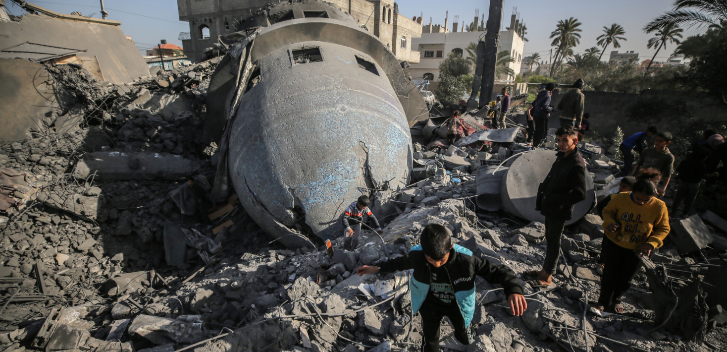 Palestinian children are walking past the rubble of the al-Bukhari mosque in Deir al-Balah, central Gaza Strip, on March 2, 2024, following an overnight Israeli air strike amid continuing battles between Israel and the Palestinian militant group Hamas. (Photo by Majdi Fathi/NurPhoto via Getty Images)