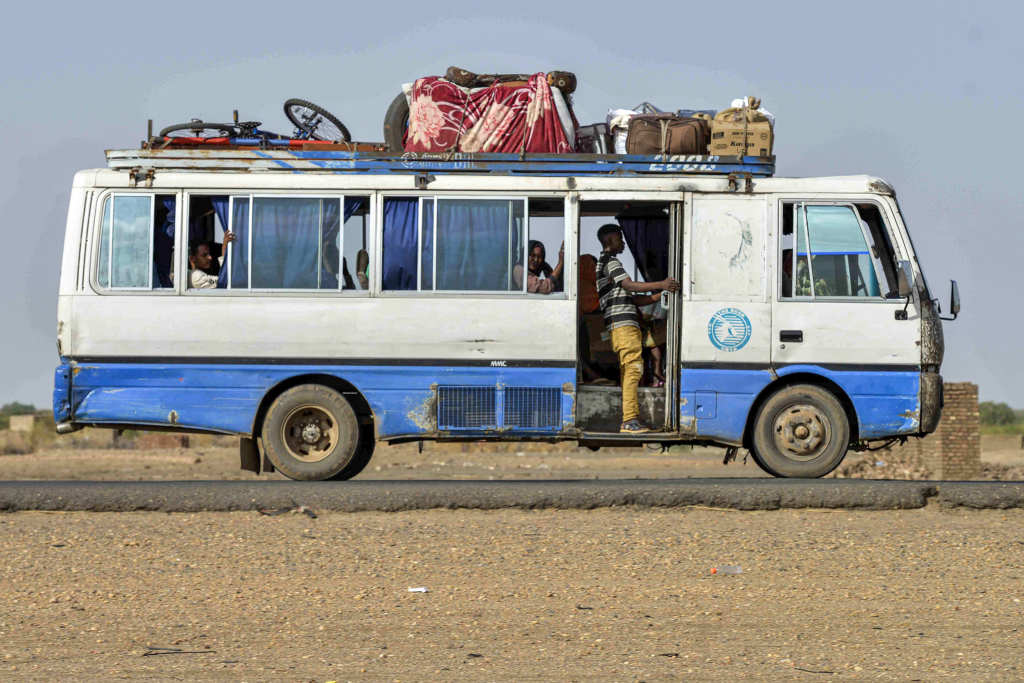 A bus carrying passengers and luggage