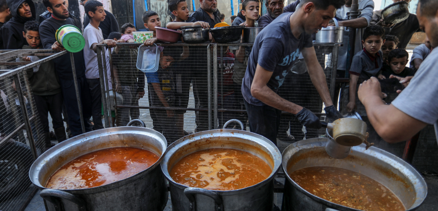 Palestinians including children, who took refuge with their families in Rafah city, wait in line to get a bowl of food distributed by charity organizations for their families, in Rafah in the Gaza Strip on March 04, 2024.