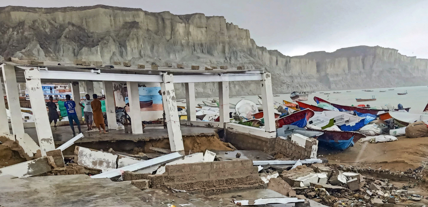 A building and boats damaged by recent storms in Gwadar, Pakistan
