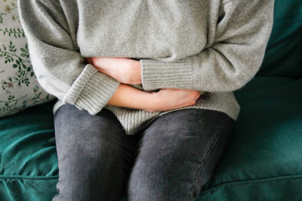 a stock image of someone clutching their stomach