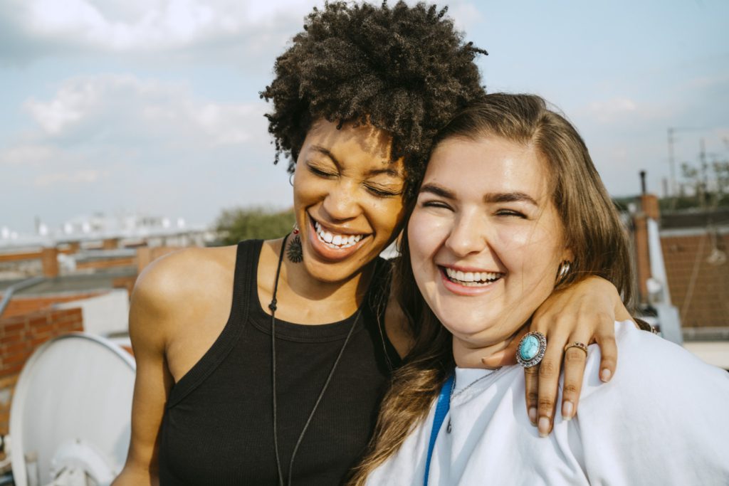 two people smiling and hugging each other