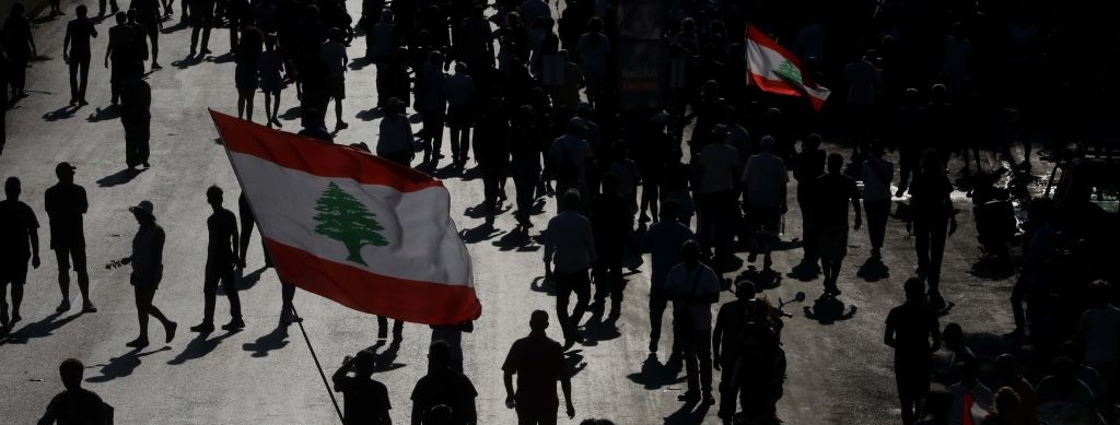 Protesters lift the Lebanese flag