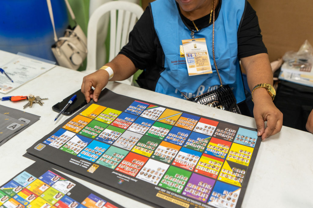 A staff member organizes the voting station during a local election in Santo Domingo on February 18, 2024. (Photo by Francesco SPOTORNO / AFP)