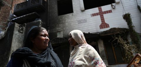 Pakistani Christian Perveen Bibi (L) weeps outside the torched Saint John Church in Jaranwala on the outskirts of Faisalabad on August 17, 2023, a day after an attack by Muslim men following spread allegations that Christians had desecrated the Koran. Police were guarding a Christian neighbourhood in central Pakistan on August 17, after hundreds of Muslim men rampaged through its streets setting fire to churches and ransacking homes over accusations of blasphemy a day earlier.
