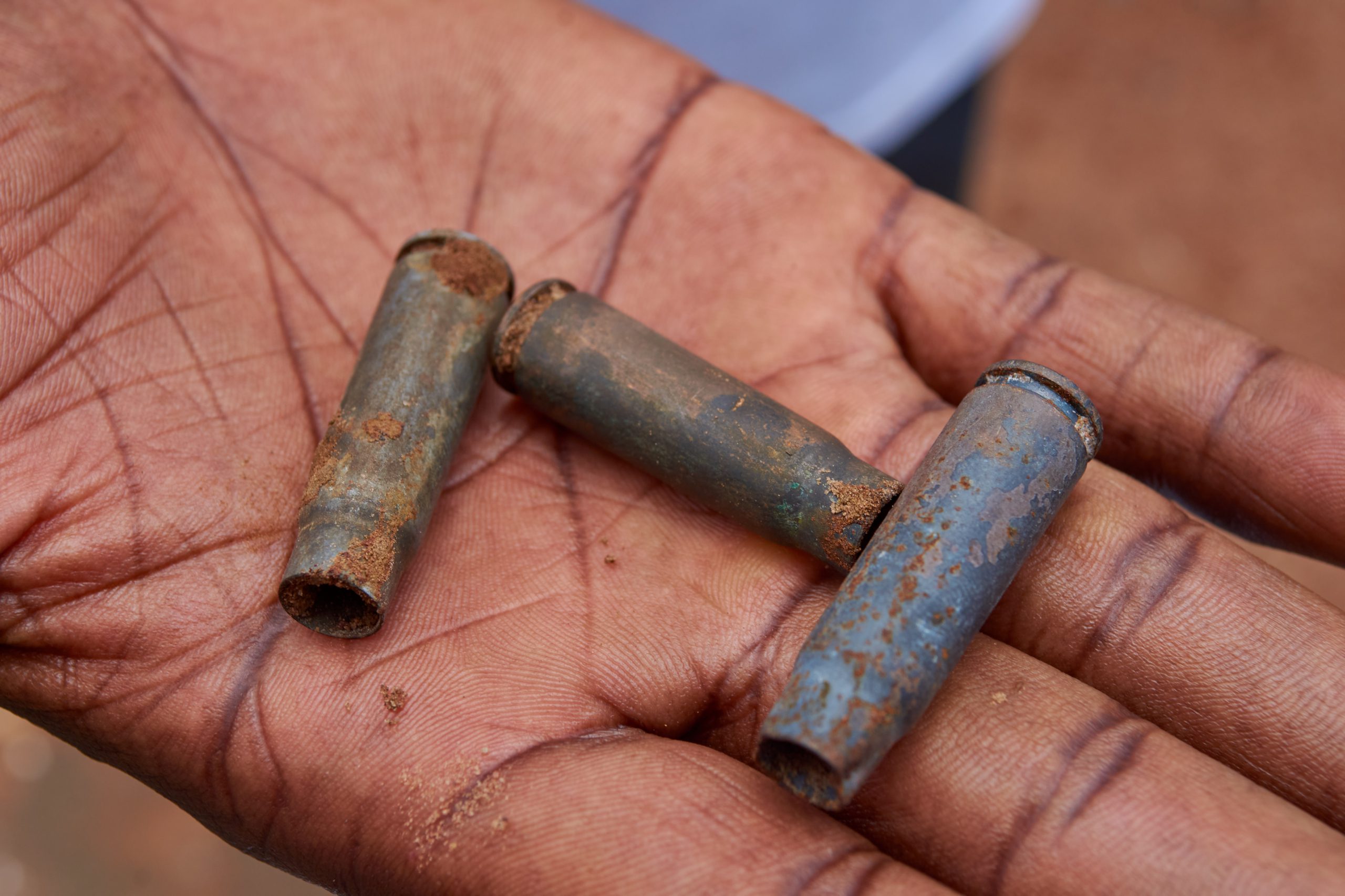 Bullet casings scattered at a community attack site in Benue State Nigeria documented by Amnesty International as evidence of militia violence against civilians