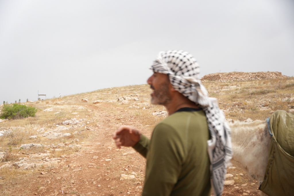A palestinian man standing on a rural area