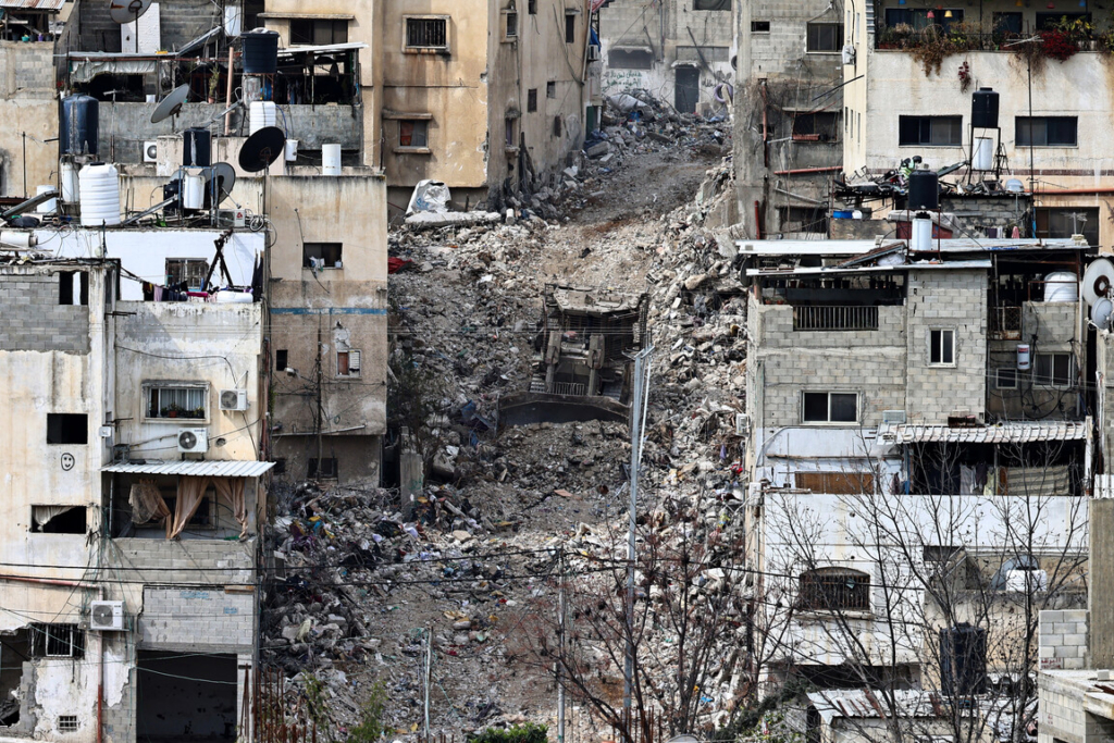 A bulldozer amid rubble in a residential area