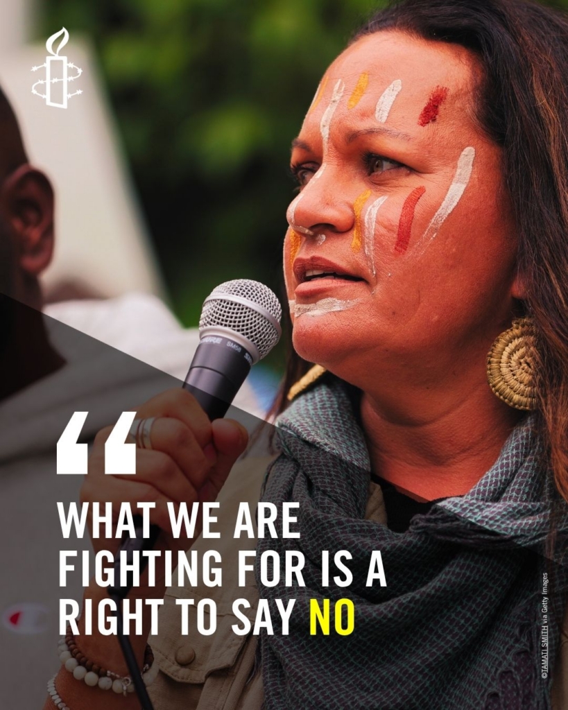 Antonia Burke in a grey scarf and red-white face markings speaking: What we are fighting for is a right to say no