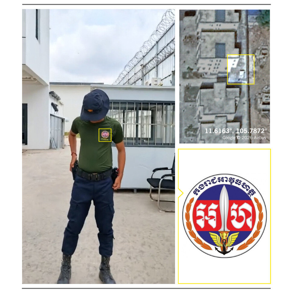 A security guard standing in front of a scamming compound, his shirt has Royal Gendarmerie of Cambodia logo.