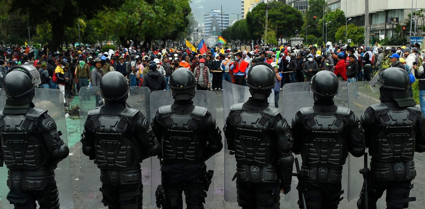Police officers stand guard as indigenous people gather in the El Arbolito park area in Quito, on June 22, 2022, on the tenth consecutive day of indigenous-led protests against the Ecuadorean government.