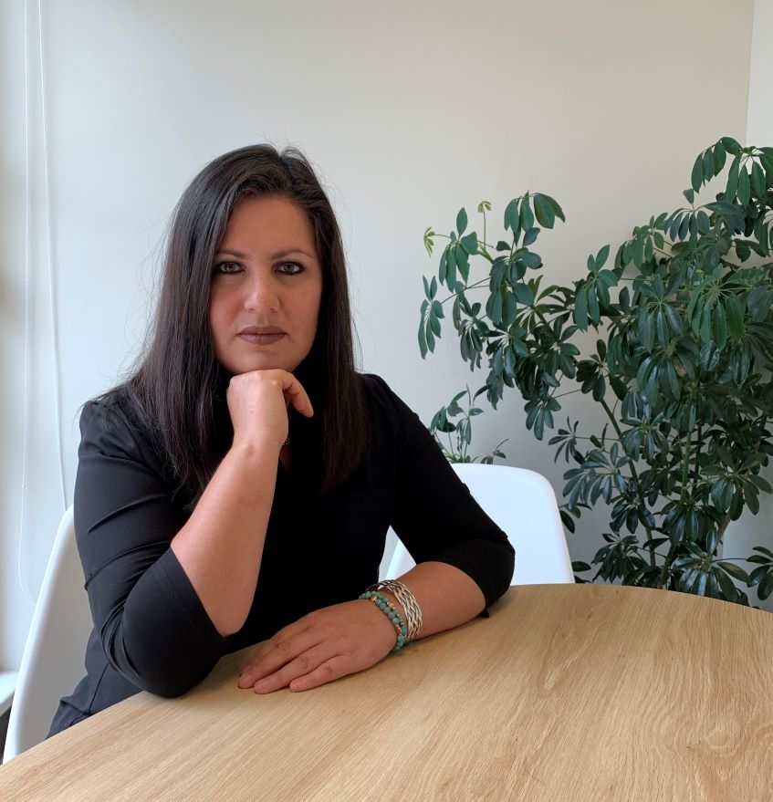 Erika Guevara Rosas sitting at a table.