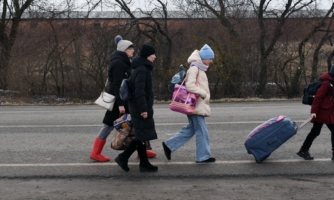 An Ukrainian family walks towards the Medyka-Shehyni border crossing between Ukraine and Poland as they flee the conflict in their country.