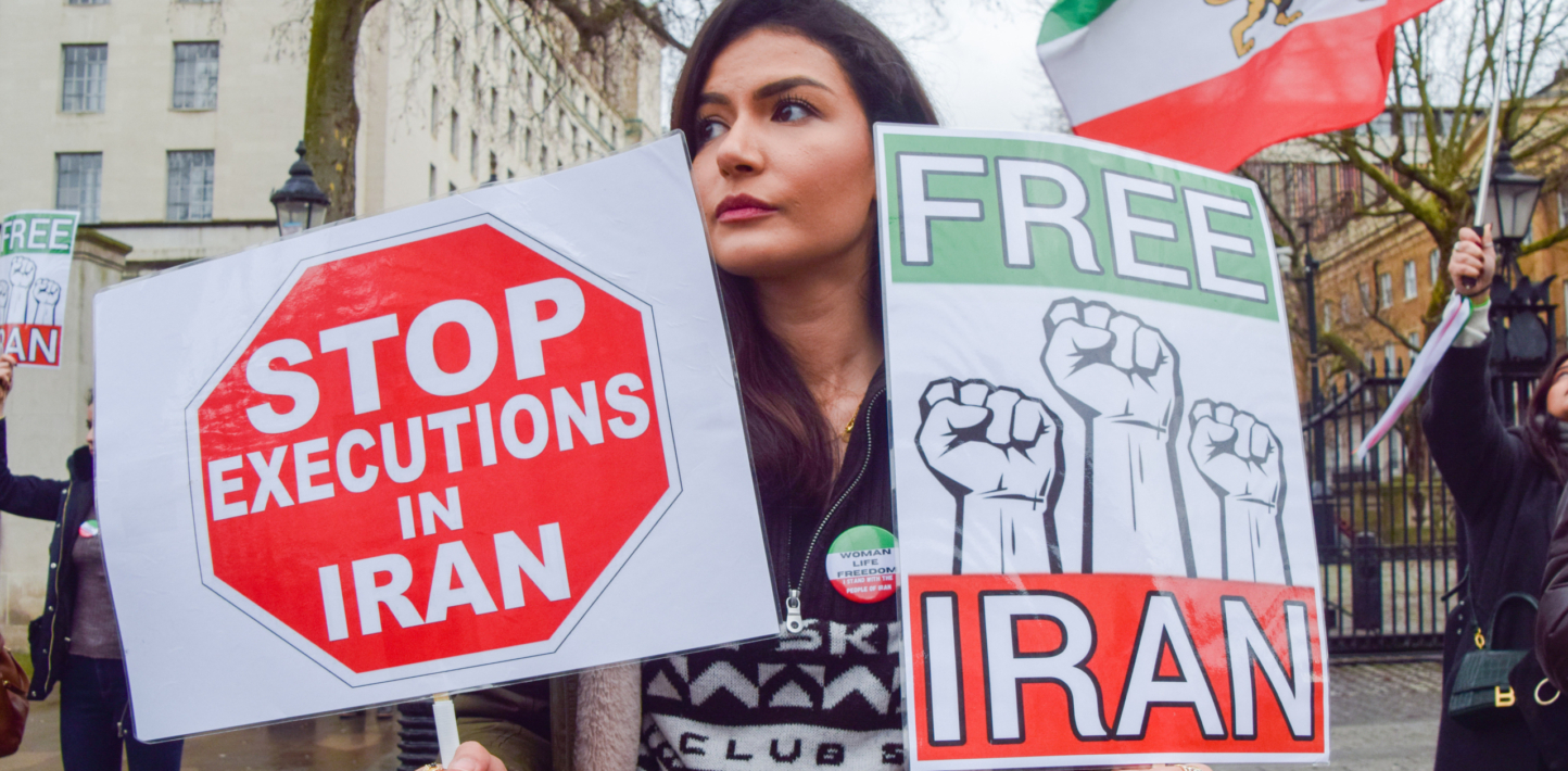 A protester holds 'Stop executions in Iran' and 'Free Iran' placards during the demonstration in London