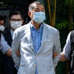 Police lead Jimmy Lai away from his home after he was arrested in August 2020.